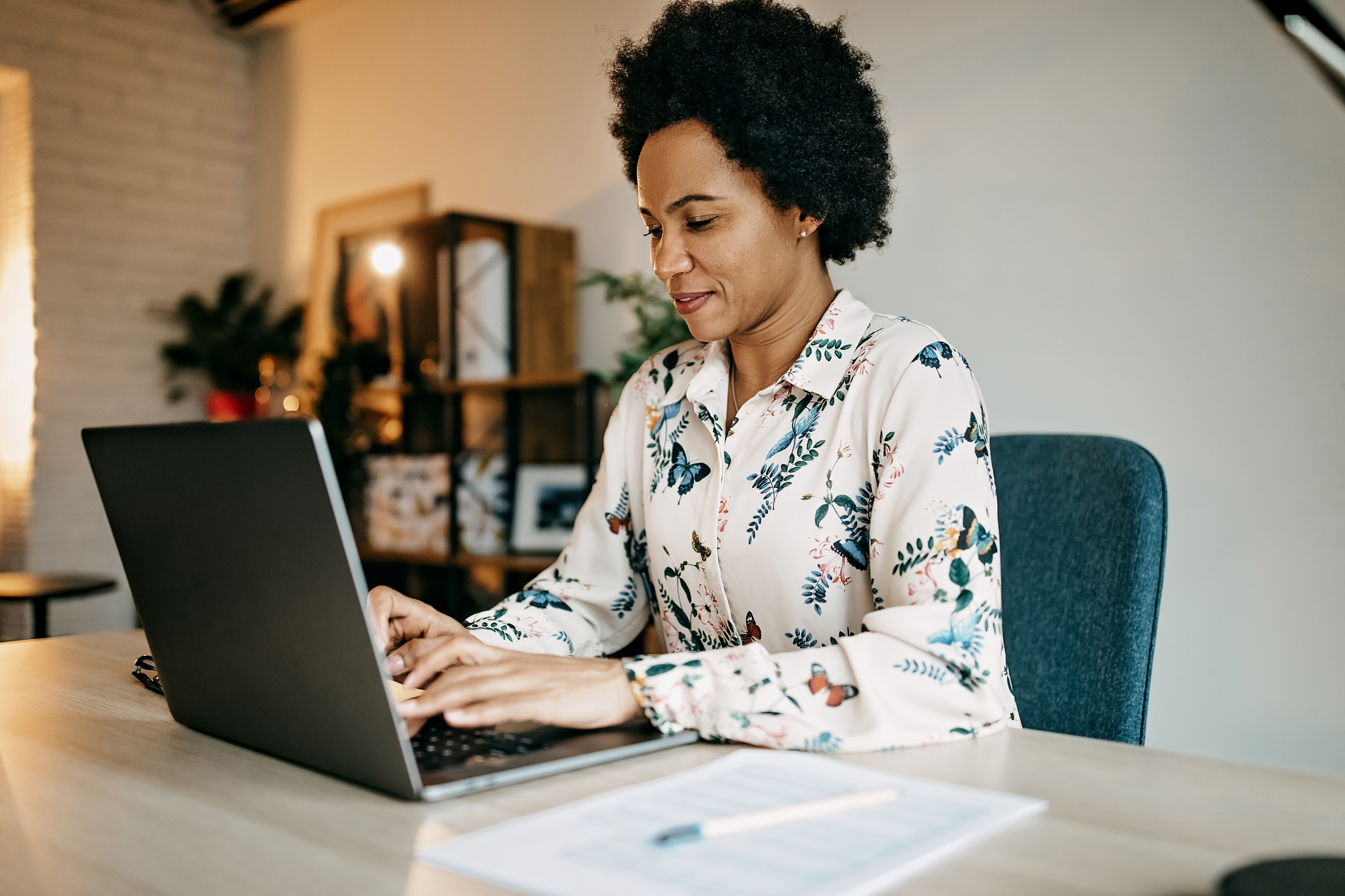 Woman at a table using a laptop